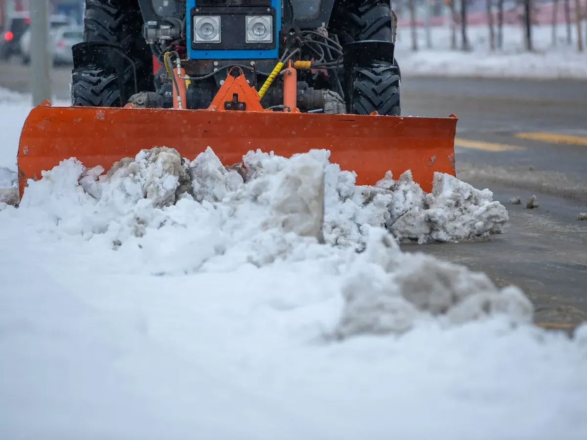 Close-up of a plow blade pushing a bank of heavy snow