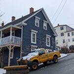 Snow plow clearing road — exclusive vs shared snow removal leads comparison