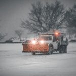 Snow plow truck with straight blade clearing a winter roadway — best snow plow brands comparison